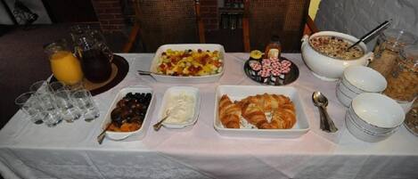 A breakfast buffet with various food items and beverages.