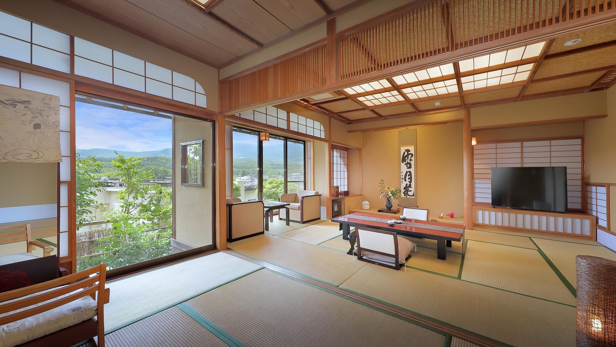 A traditional Japanese-style room with tatami flooring, a low table, and sliding doors.