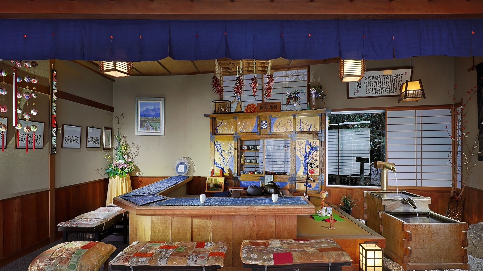 A traditional Japanese inn with tatami mat seating, a reception desk, and various cultural decorations.