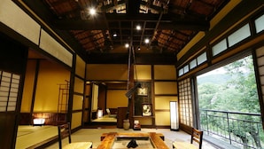 A traditional Japanese room with tatami flooring, a low table, and sliding doors. - Shirakabeso (Izu)