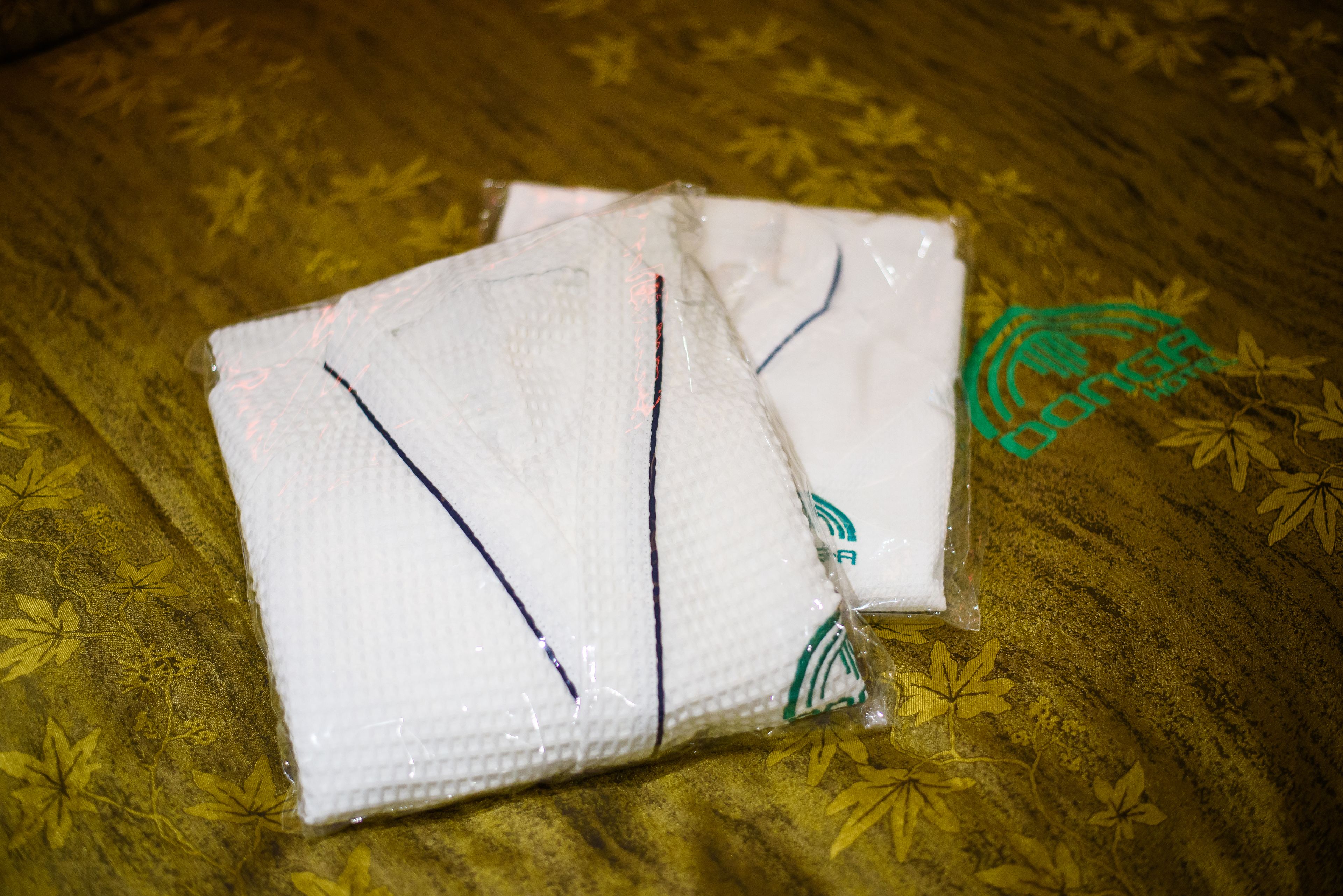Two white packages on a patterned fabric surface.