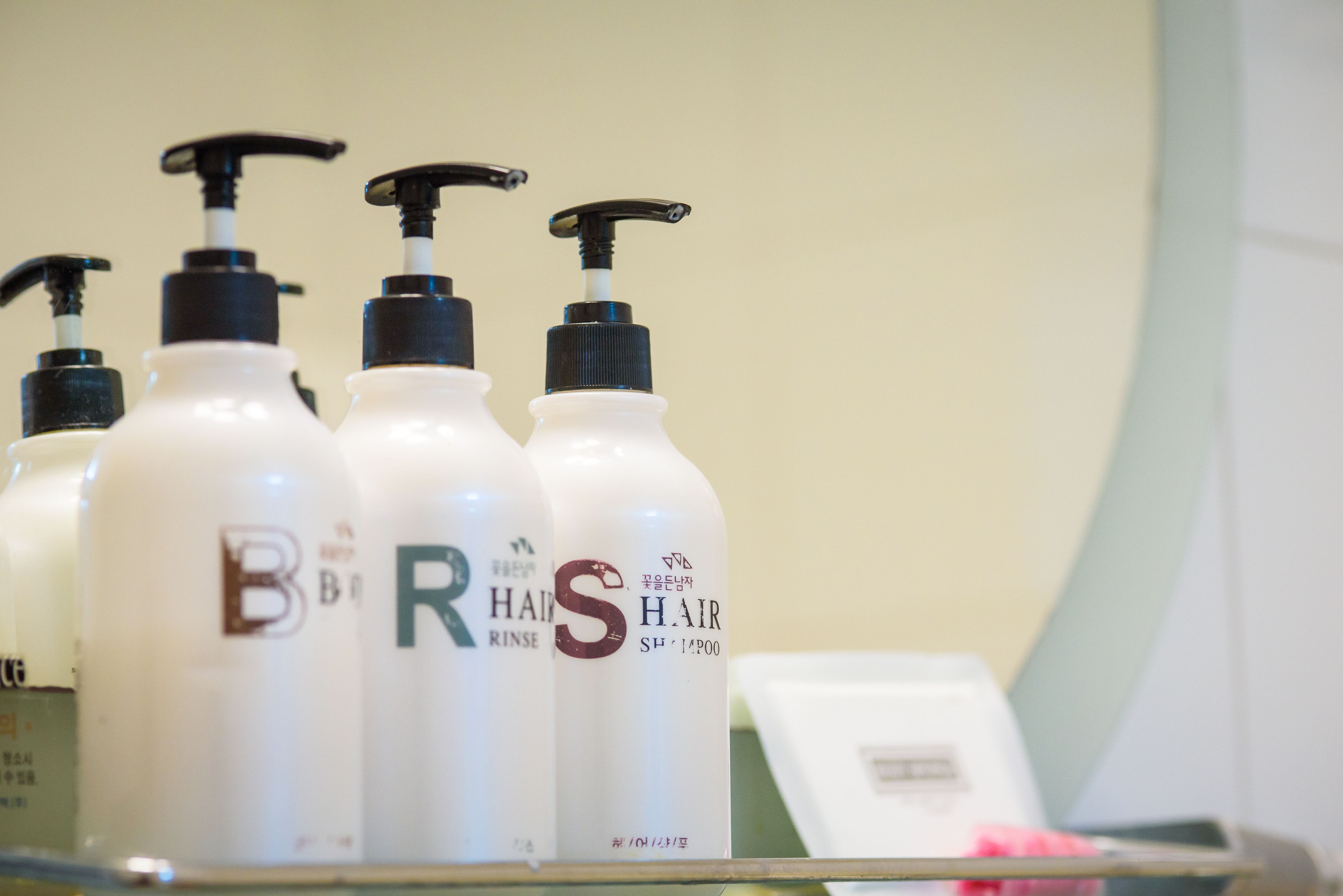 A row of hair care products on a shelf.