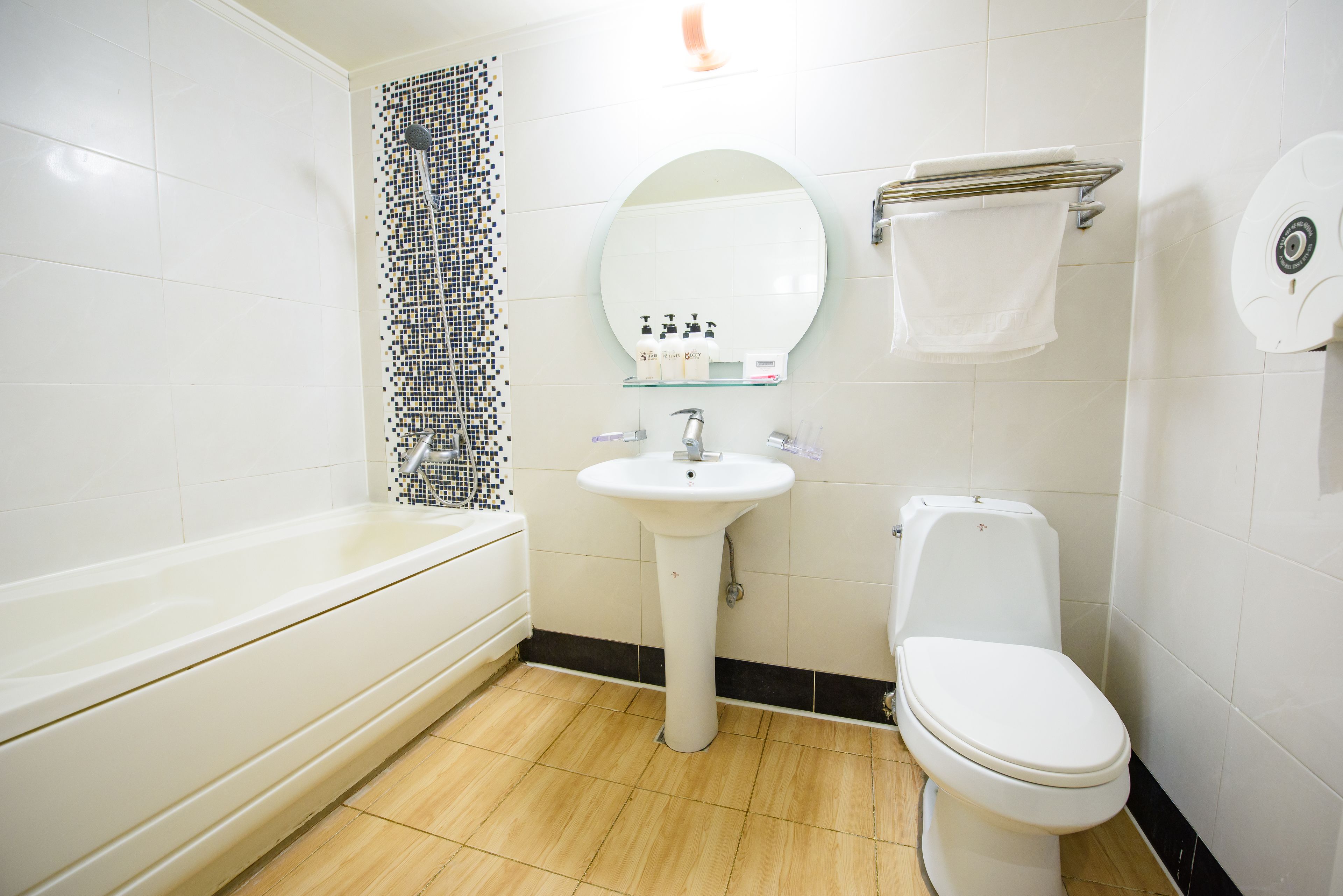 A bathroom with a bathtub, a sink, and a toilet.