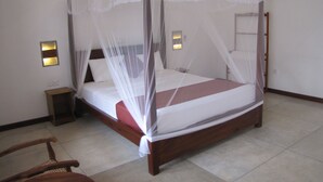 A four-poster bed with a canopy, bedside tables, and wall-mounted lights. - Weligama Ocean Breeze (Weligama)
