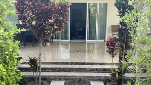 A modern outdoor area with a marble pathway leading to a glass door entrance. - Nice Villa in Hua Hin (Hua Hin)