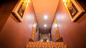 A staircase with ornate railings and a central light fixture. - Amethyst Boutique Hotel Fisherman's Village (Koh Samui)