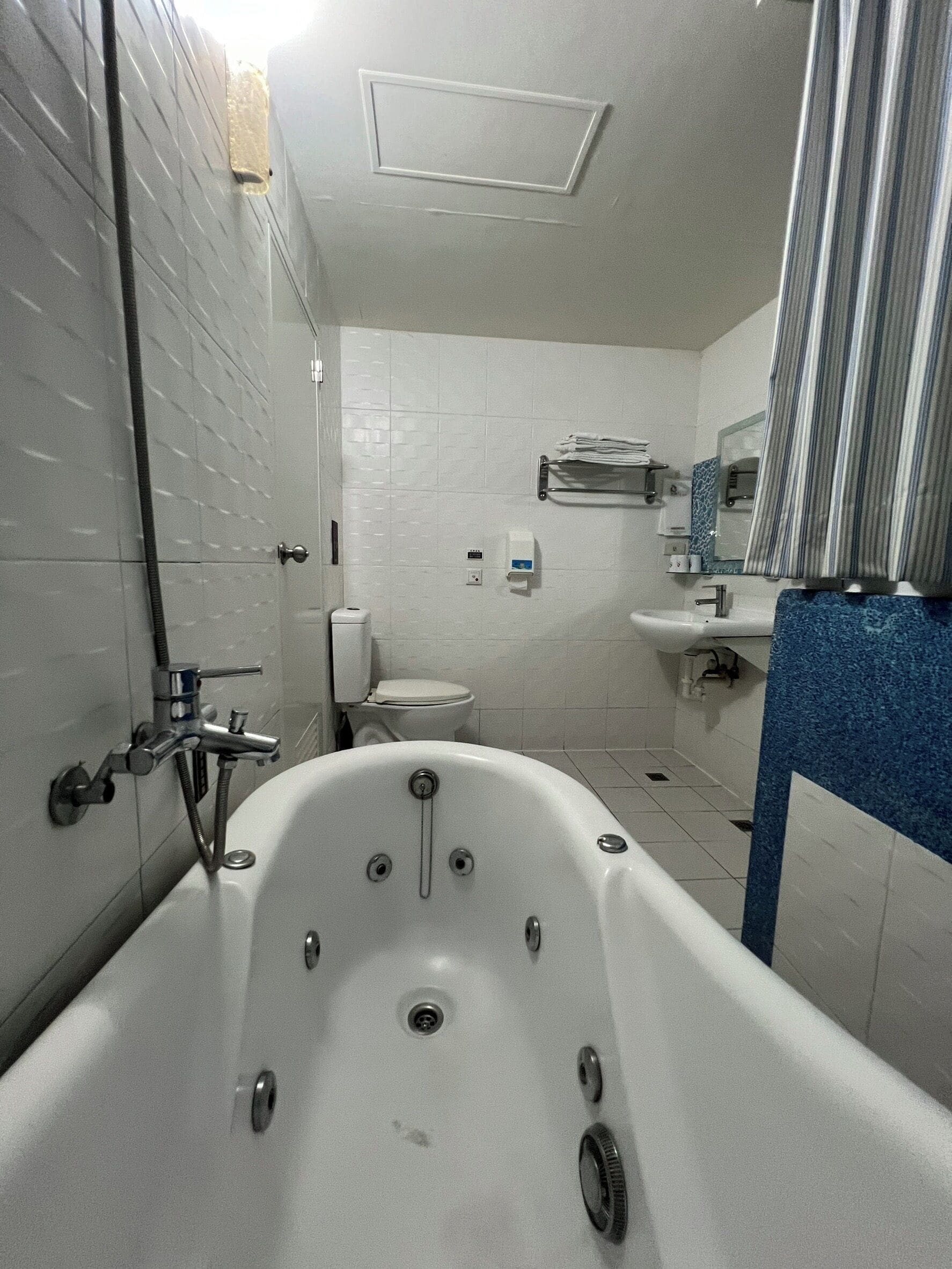 A bathroom with a freestanding bathtub, a toilet, a sink, and a shower.