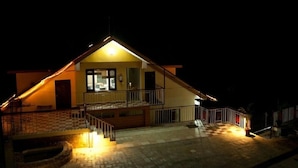 A two-story house with a balcony and a staircase leading to the upper floor. - Dragon I Resorts (Dharamshala)