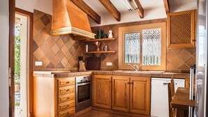 A kitchen with wooden cabinets, a built-in oven, and a dishwasher. - SINGLE FAMILY HOUSE ISOLATED WITH POOL, RURAL HOUSE IN A LAND OF 35. 000M2 (Selva- Cami Selva- Mallorca)