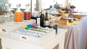 A buffet table with various food items, condiments, and beverages. - Casa Turrisi (Taormina)