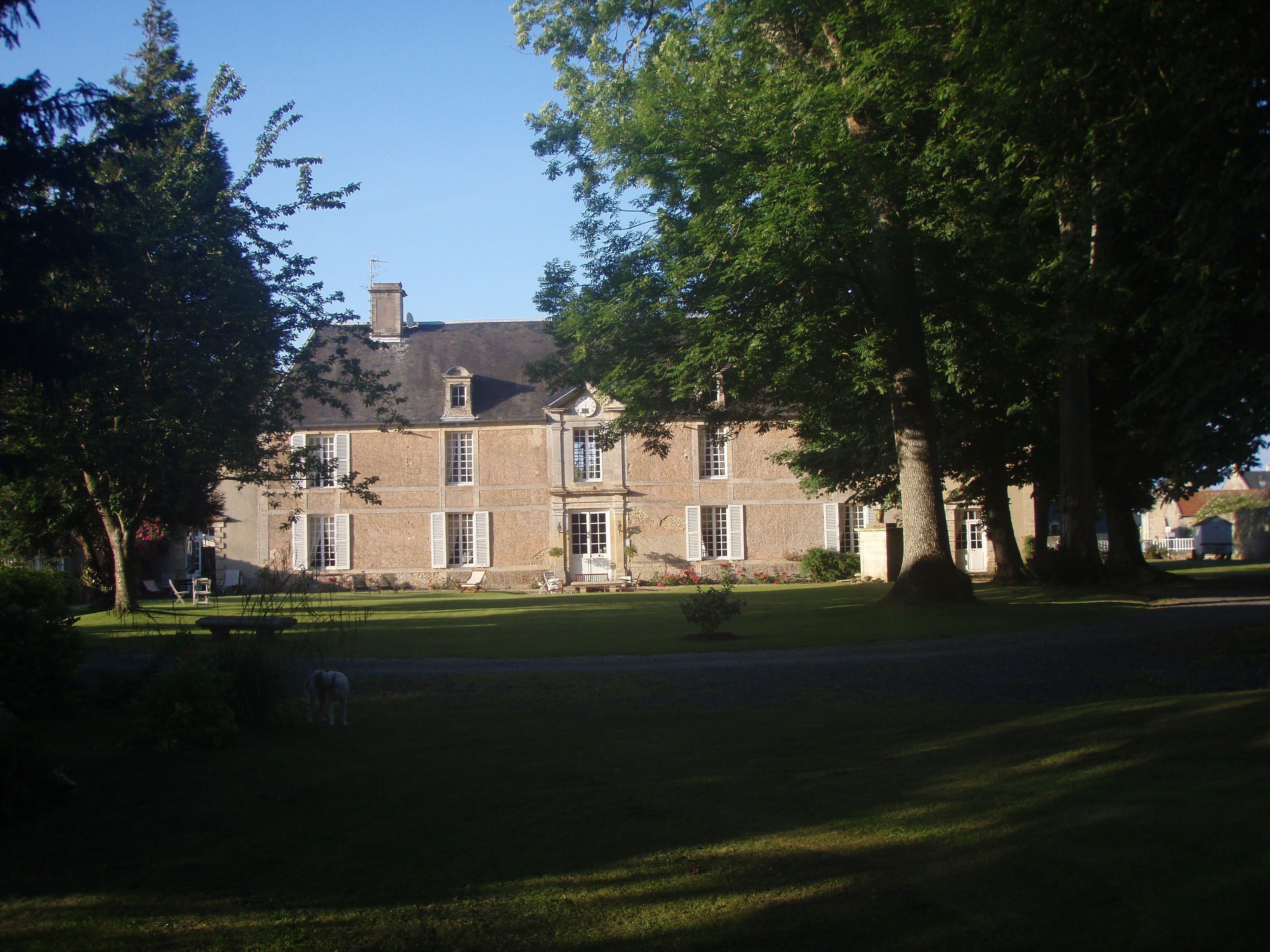 A large, historic building with a symmetrical facade, multiple windows, and a central entrance.