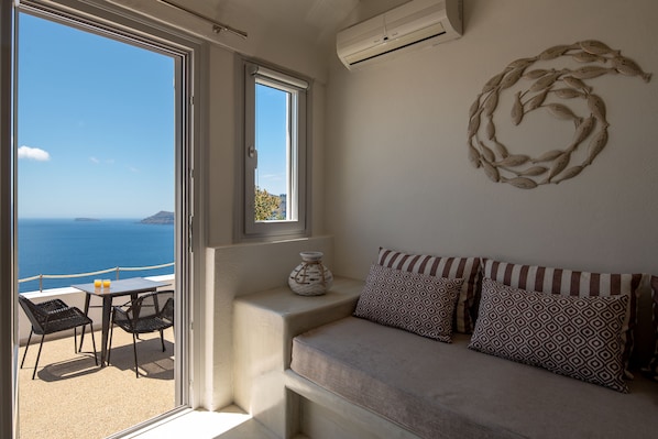 Deluxe Room, Hot Tub (Cave, Caldera View) | Living area | Flat-screen TV