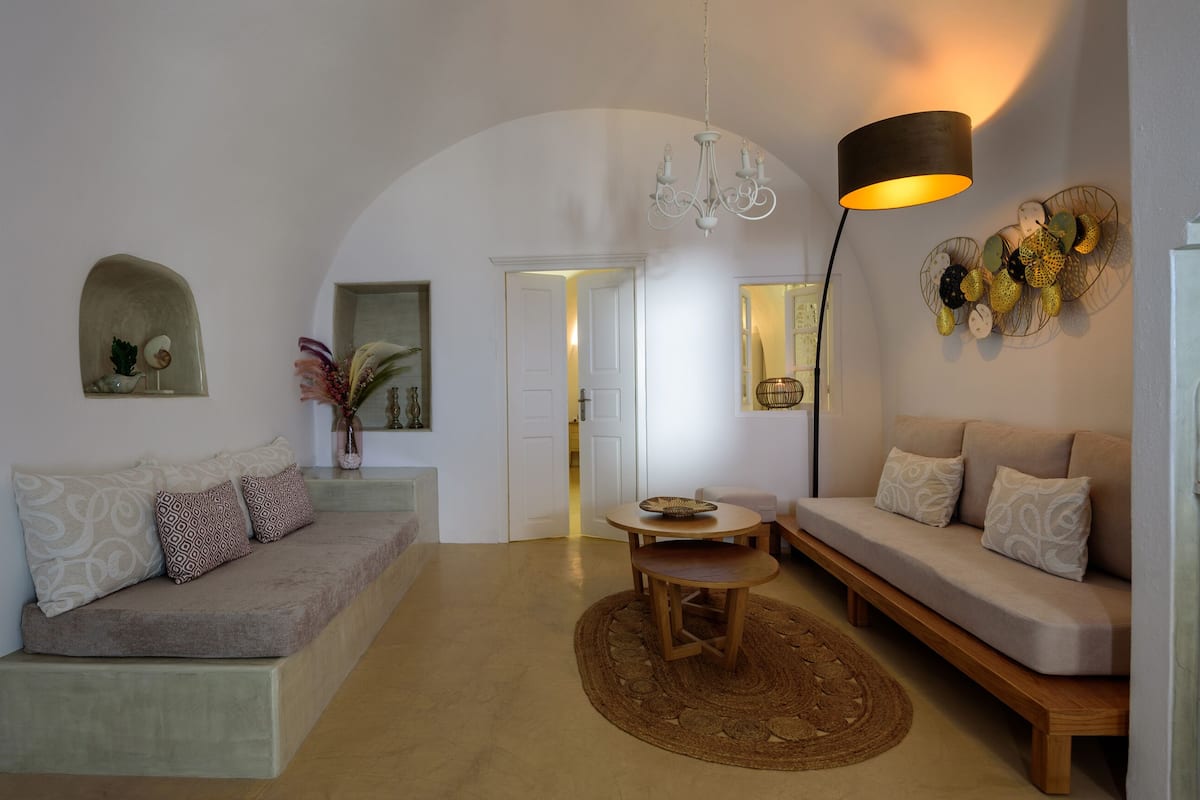 A modern living room with a sofa, a coffee table, and a lamp.