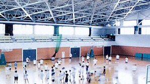 A gymnasium with a high ceiling, basketball court, and multiple doors. - Hotel Tango Nakamuraso (Miyazu)