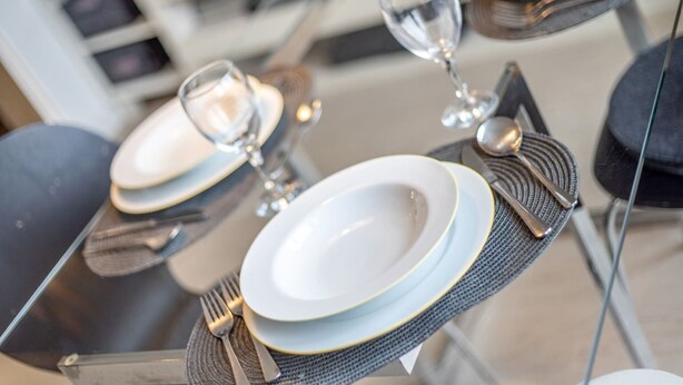 A dining table set with plates, glasses, and cutlery. - Apartment 5 (ID 171), Germany (Sankt Peter-Ording)