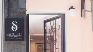 A building entrance with a sign reading "DANEZIS CITY STARS DELUXE SERVICED APARTMENTS." - Danezis City Stars (Rhodes)