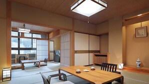 A traditional Japanese room with tatami flooring, a low wooden table, and sliding doors. - Seijaku to Magokoro no Yado Nanaeyae (Nikko)