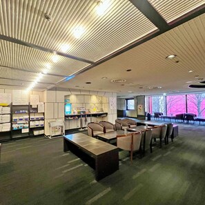 A conference room with a long table and chairs, a reception desk, and a bulletin board with papers. - HOTEL THE CENTRE UTSUNOMIYA (Utsunomiya)