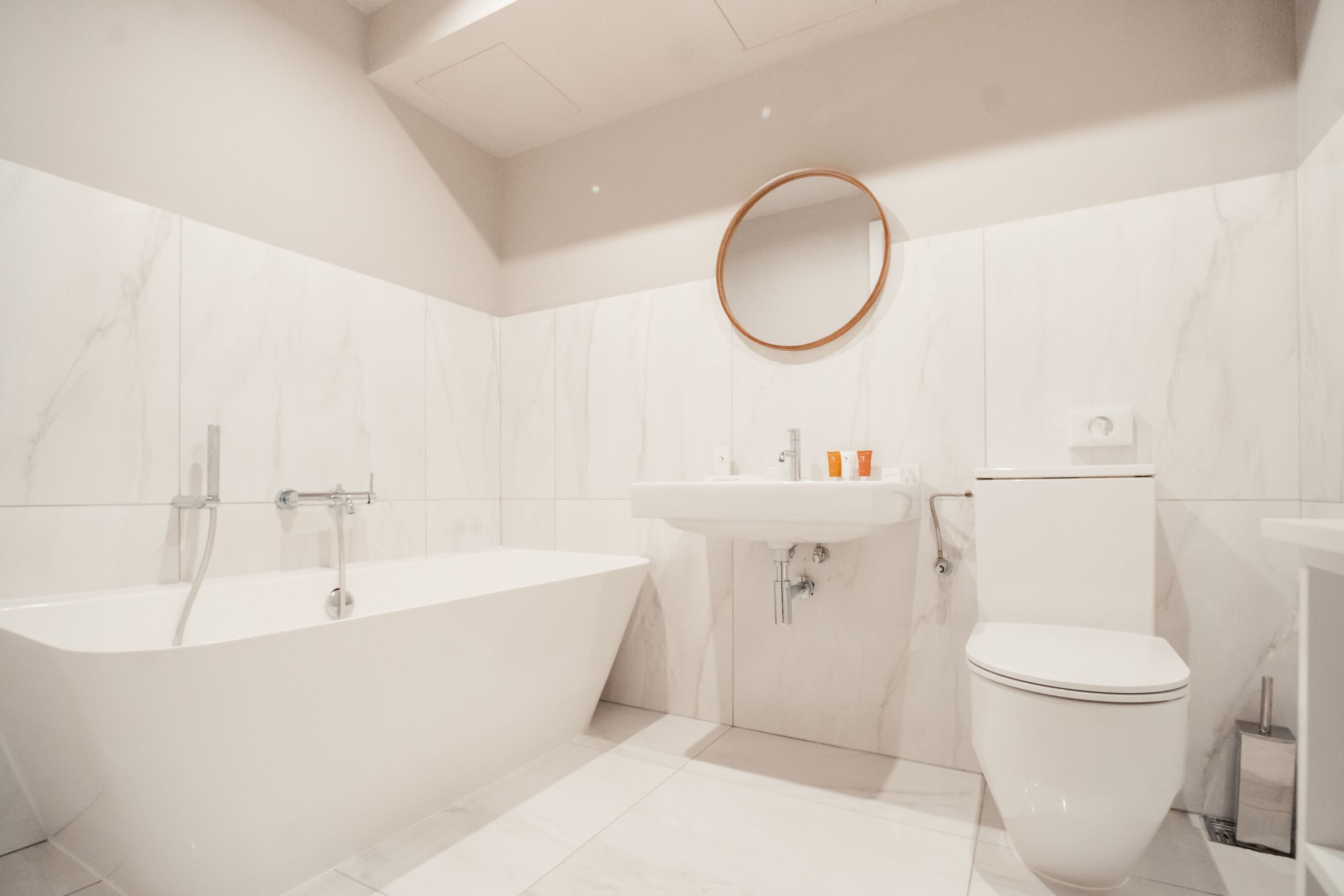 deluxe double or twin room | bathroom | rainfall showerhead, free toiletries, hair dryer, slippers