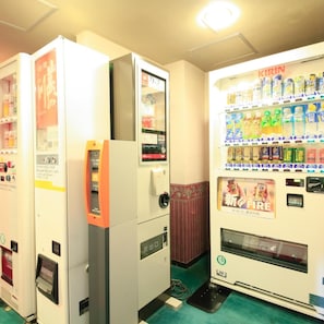 Vending machines with various drinks and snacks, a fire extinguisher, and a payment terminal.
