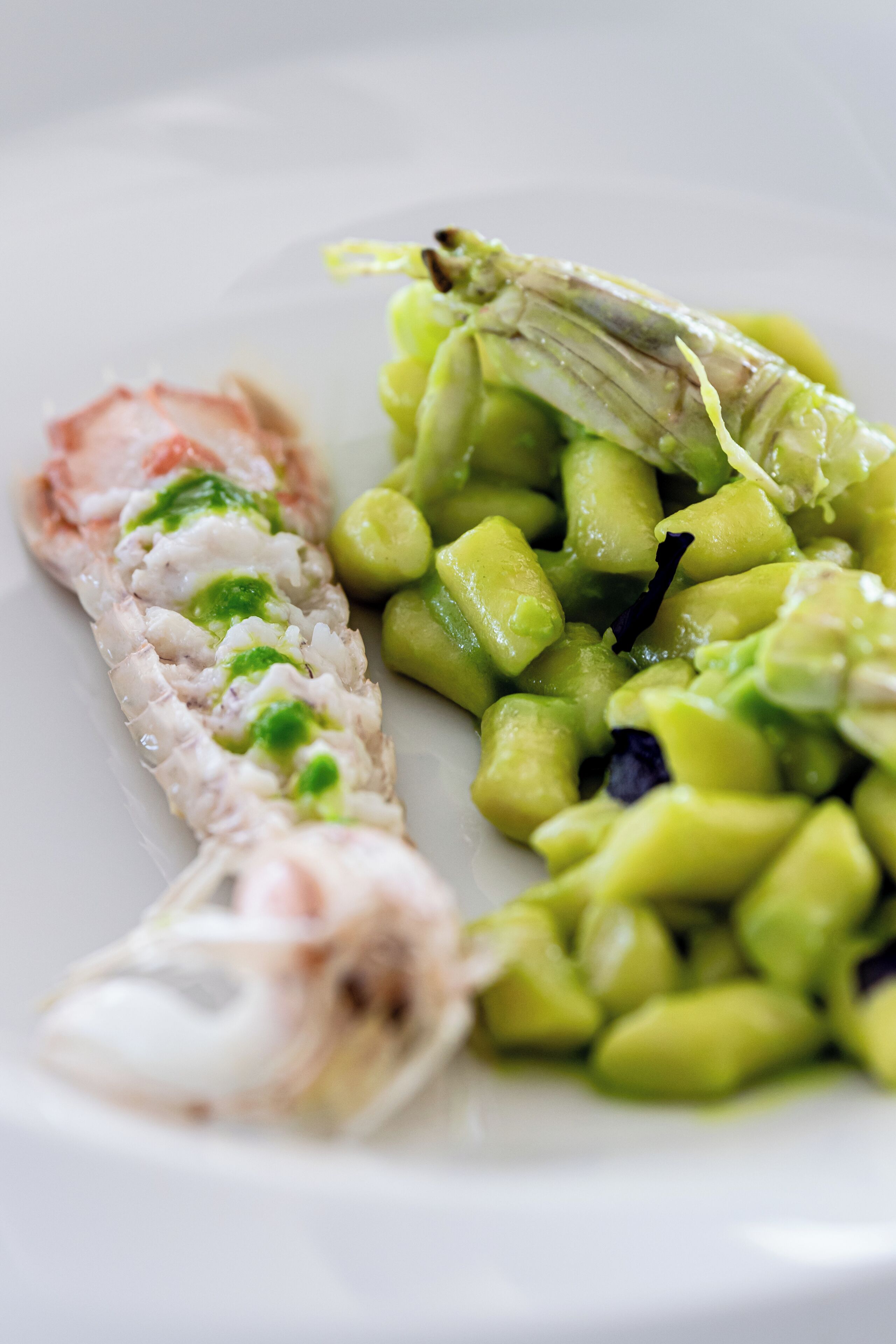 A plate with a piece of fish and green vegetables.