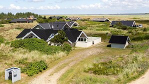A cluster of modern houses with sloped roofs, surrounded by grassy fields and a clear sky. - Pet friendly home in Hvide Sande with WiFi (Hvide Sande)