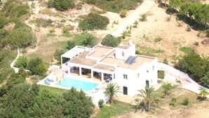 A white villa with a swimming pool, multiple balconies, and a garden. - Villa Chevalier at Kiotari Beach,  south of Lindos (Dodekanissos)
