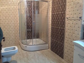 Shower, hair dryer, slippers, towels