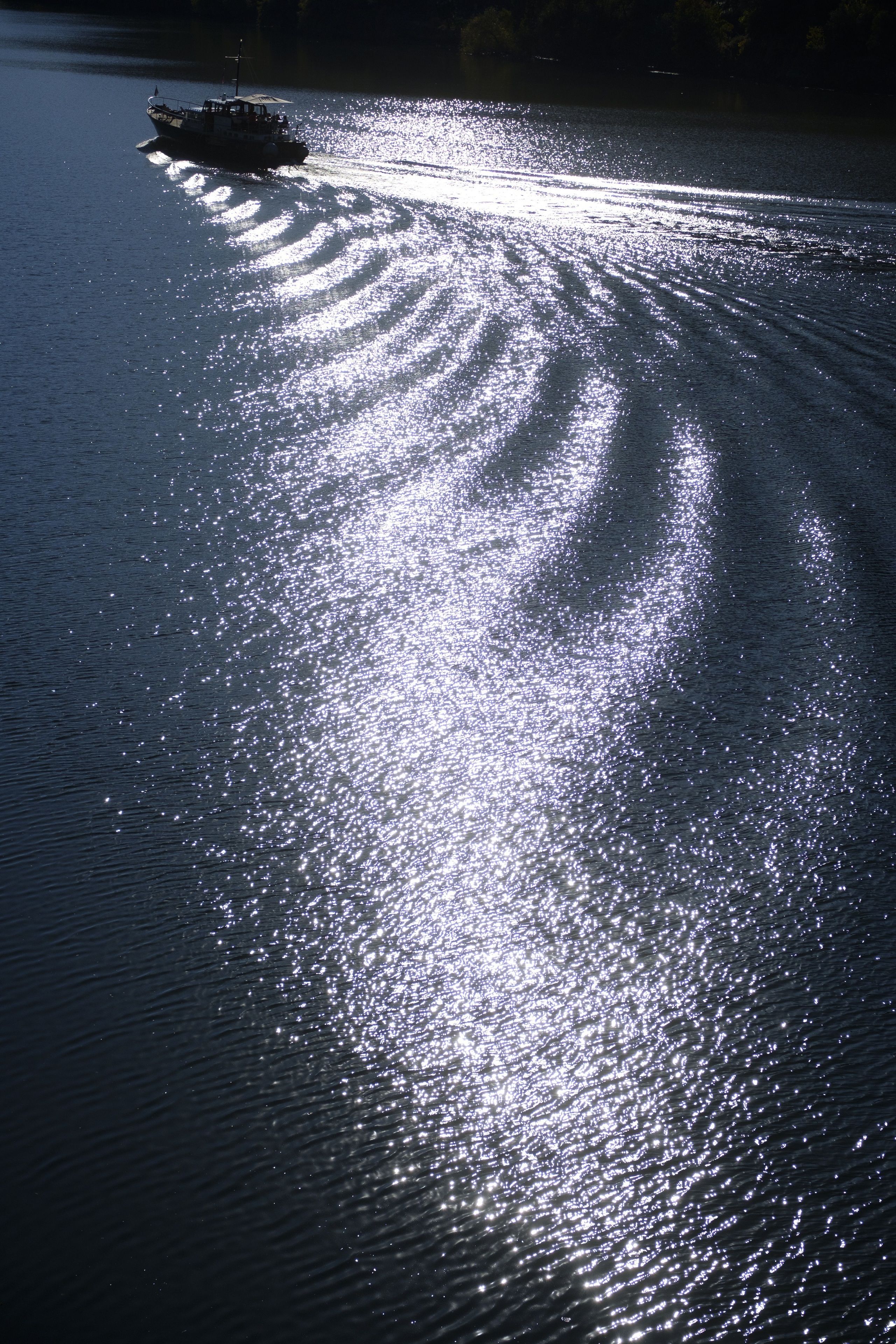 A boat creating a wake on a body of water.