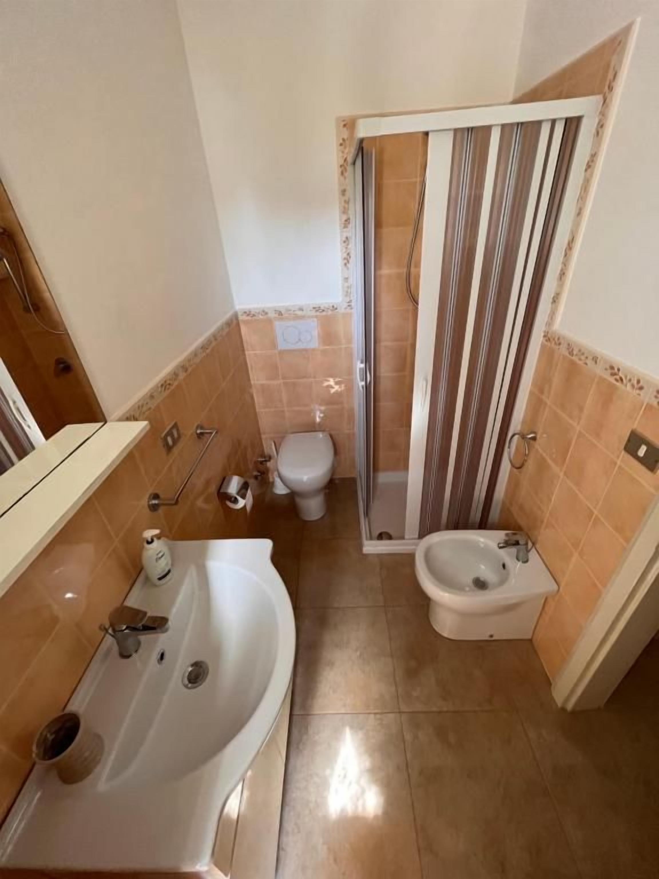 A bathroom with a bathtub, toilet, and shower.