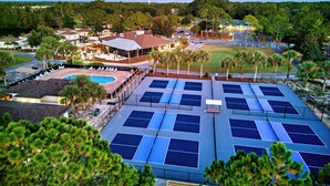A resort with multiple tennis courts, a swimming pool, and a golf course. - St James Bay Golf & Pickleball Resort (Carrabelle)