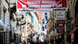 A bustling street with a large banner advertising the Truffle Market. - Le Camere di Gio (Alba)