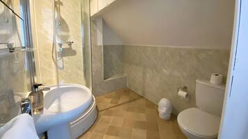 A modern bathroom with a glass-enclosed shower, a sink, a toilet, and a bathtub.