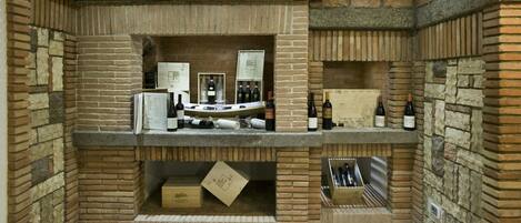 A wine cellar with multiple shelves displaying wine bottles and boxes.