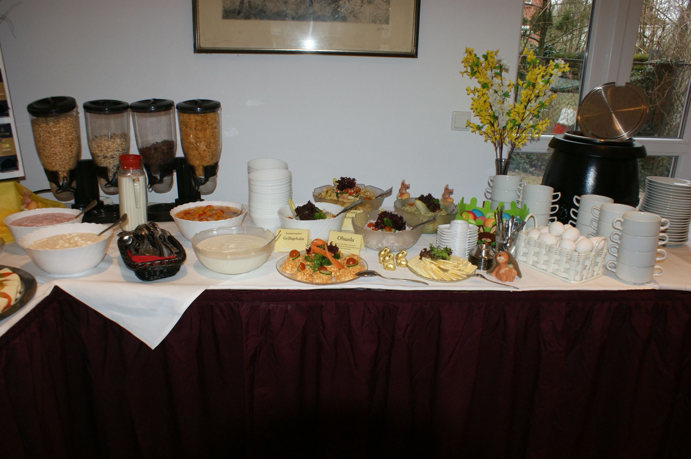 A buffet table with various food items and containers.
