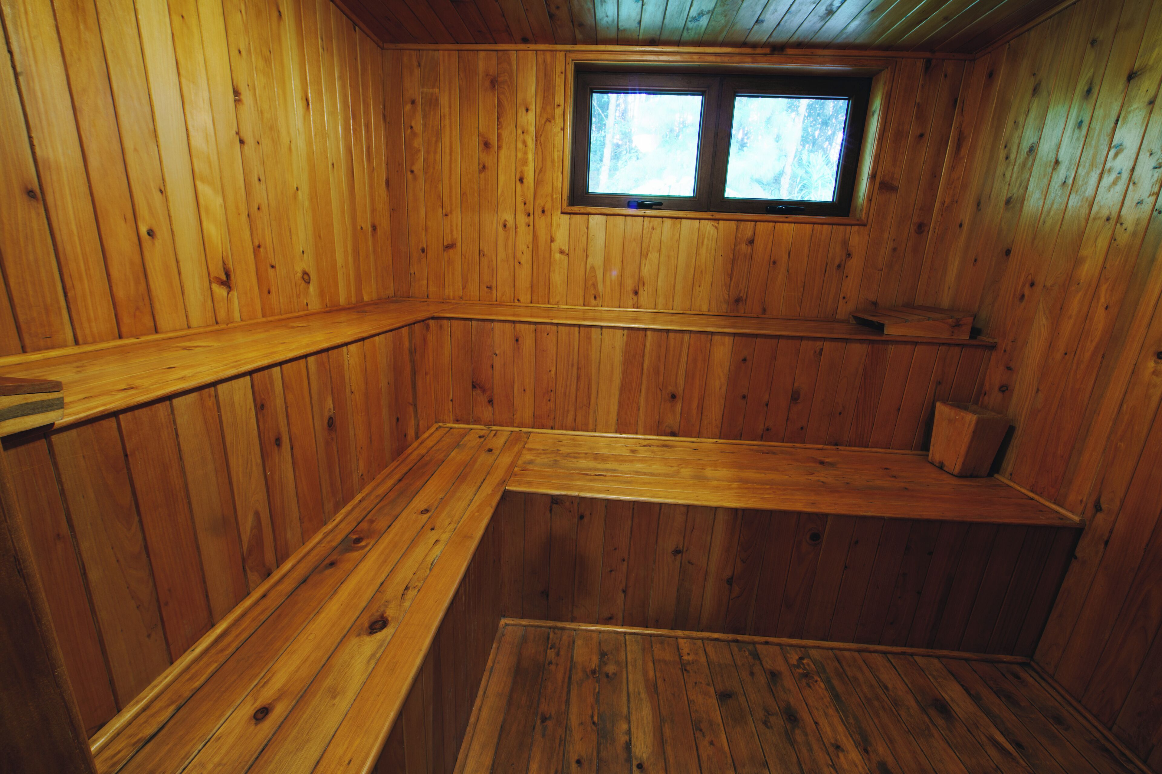 A wooden cabin with a built-in bench and a window.