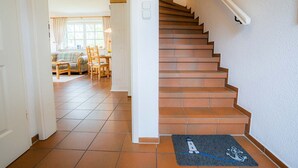 A staircase leading to a landing with a doormat featuring a lighthouse design. - Holiday house Witte Hus (ID 175) - Holiday house "Witte Hus" (ID 175) (Sankt Peter-Ording)