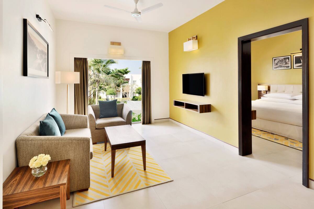 suite, 1 king bed, non smoking, pool view (balcony) | living room | 42-inch flat-screen tv with satellite channels, tv