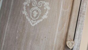 A wooden door with a heart-shaped design and a heart-shaped handle.