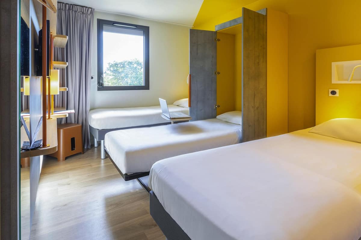 Room, Multiple Beds | Laptop workspace, soundproofing, iron/ironing board, free WiFi