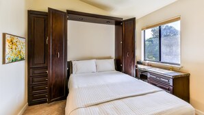 A bedroom with a bed, a desk, a window, and a ceiling fan. - LAKE PALMS 7 - Newly Updated Sanibel Condo Overlooking Lagoon (Sanibel)