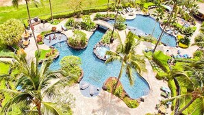 An aerial view of a resort with multiple swimming pools, palm trees, and lounge areas. - Luxurious Beach Villa 3BR/2.5B in KoOlina~FREE WIFI, GYM w/ ALL NEW UPGRADES (Kapolei)
