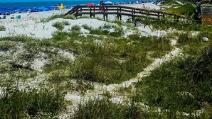 A beach with a wooden walkway, sandy dunes, and a clear blue sky. - Mayo Clinic under 15 min (6 miles), Beach under 2 min walk (Jacksonville Beach)