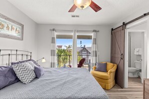 A bedroom with a bed, a chair, a balcony, and a view of the outside. - Spacious 3 bed 2.5  ba unit, close to the beach, heated pool, tennis, pickle bal (Santa Rosa Beach)