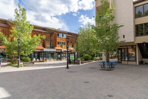 A paved plaza with benches, a ski shop, and a restaurant. - 100 Steps to Gondola! A/C, Steps to multiple restaurants, shops, and rentals! (Vail)