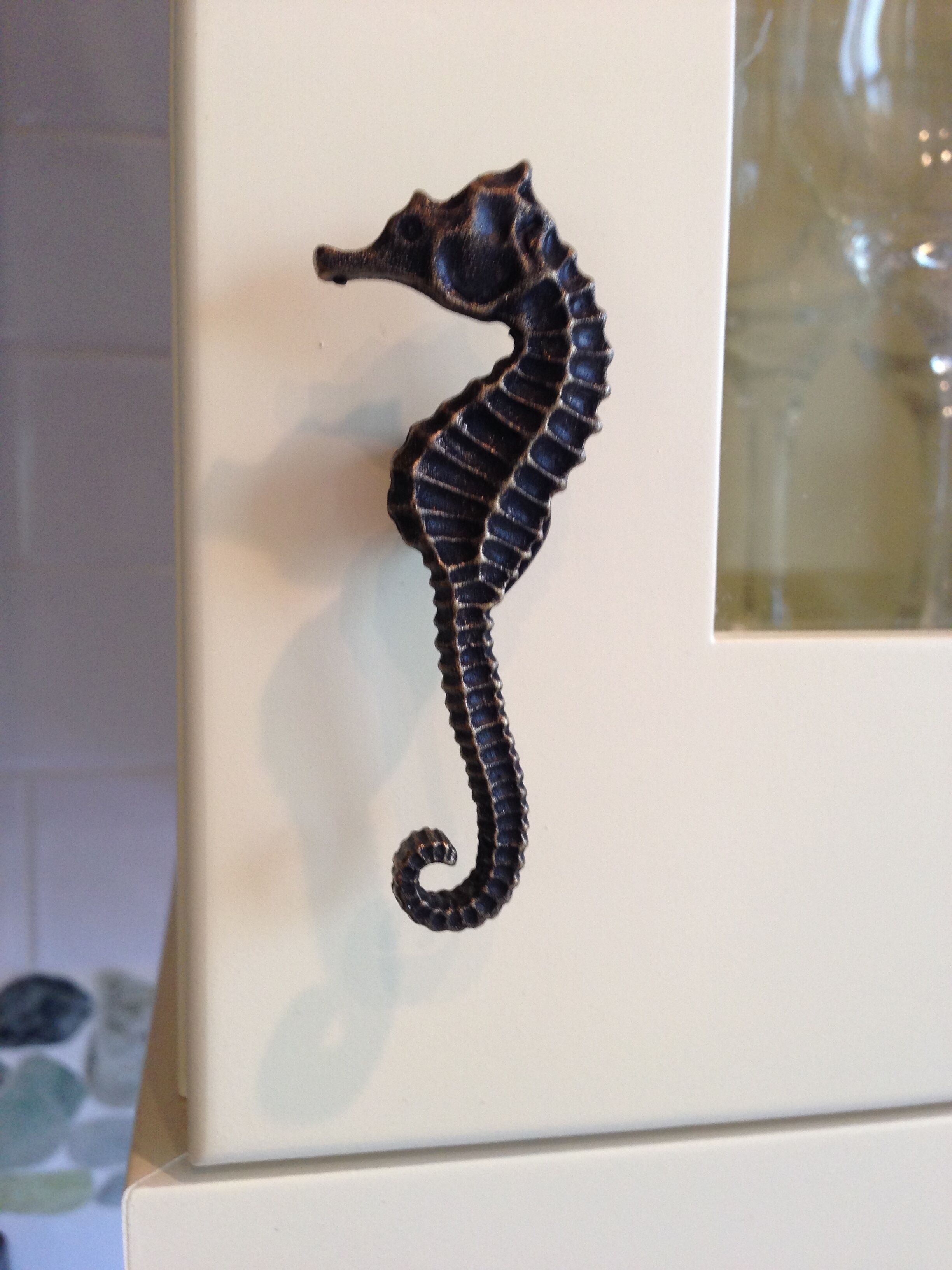 A seahorse decal on a white surface.