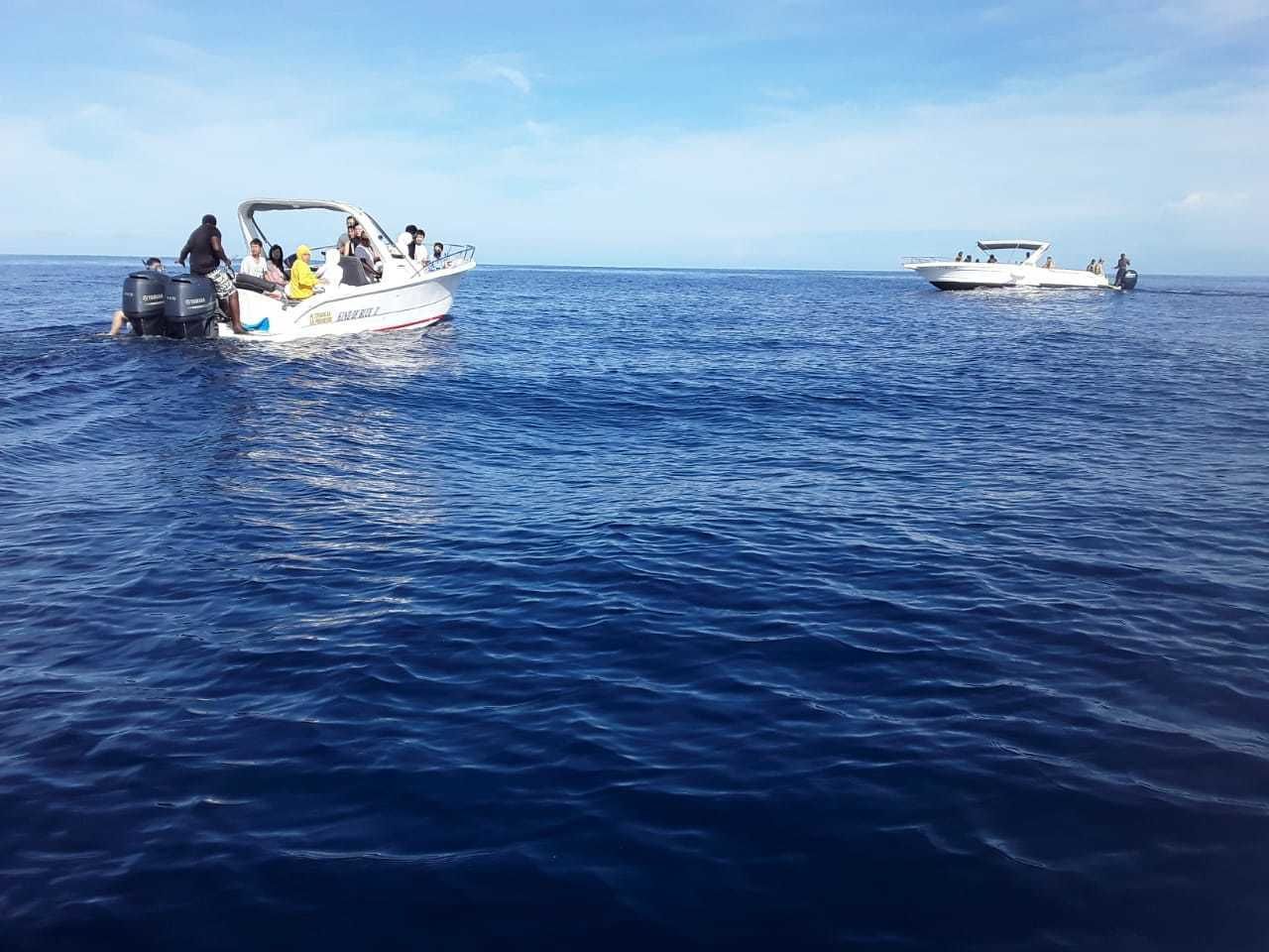 Two boats on a calm sea.
