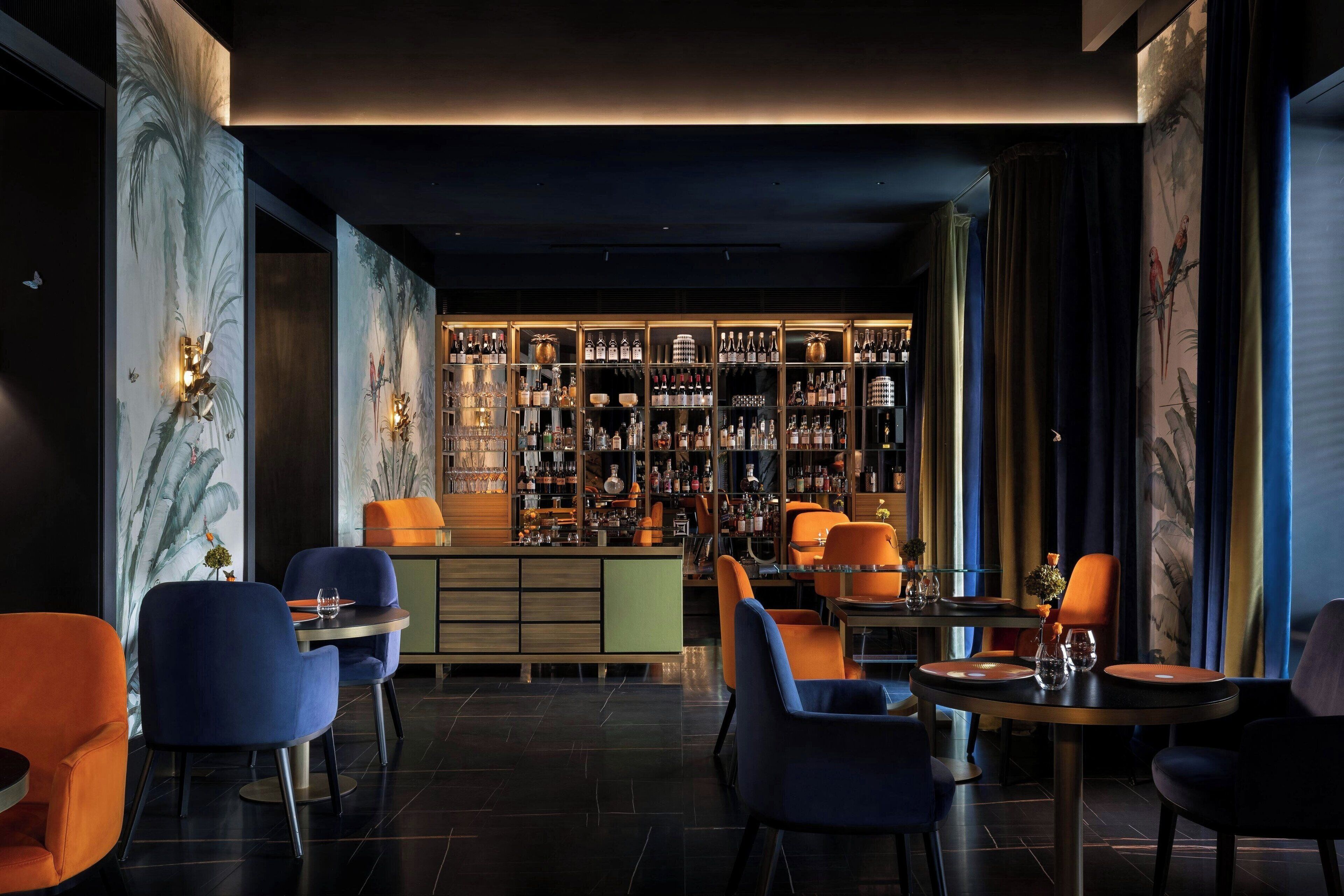 A bar area with seating and a well-stocked liquor display.