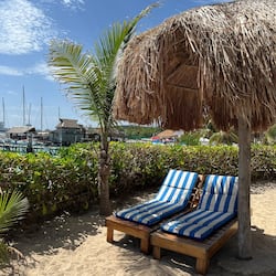 On the beach, white sand, sun loungers, beach umbrellas