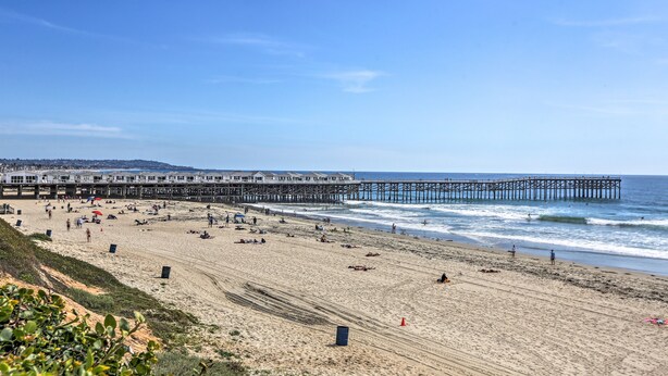 A beach with a pier extending into the ocean, sandy beach, and a clear sky. - Pacific Beach Apartment: Walk to Beach & Pier! (San Diego)
